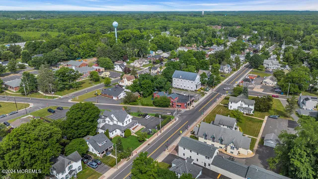 an aerial view of a house with a yard and lake view