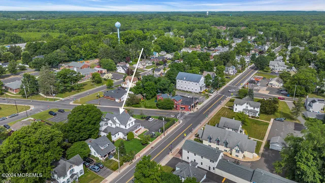an aerial view of a house with a yard and lake view