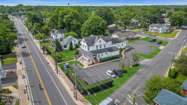 an aerial view of residential houses with outdoor space and street view