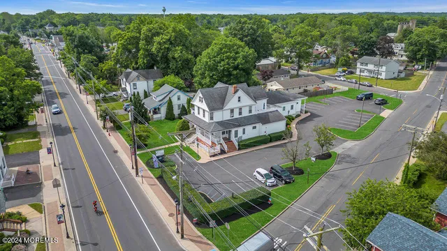 an aerial view of residential houses with outdoor space and street view