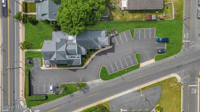 an aerial view of a house with outdoor space tennis court