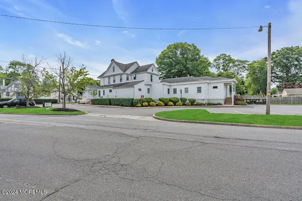 a house with a yard and a car parked in front of it
