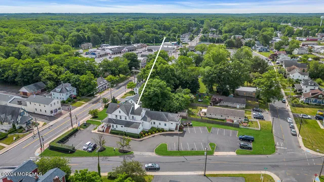an aerial view of residential houses with outdoor space and parking