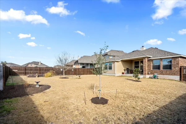 a view of a house with swimming pool and sitting area