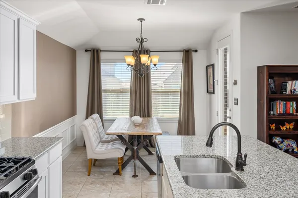 a kitchen with a table chairs and a stove