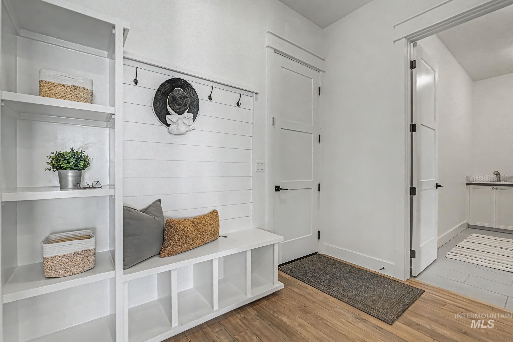 6521 South Pemberley Way Meridian, ID 83642 - Photo 19 of 42 Entryway mudroom featuring built-in shelving, a bench with cubby storage, and wall-mounted hooks
