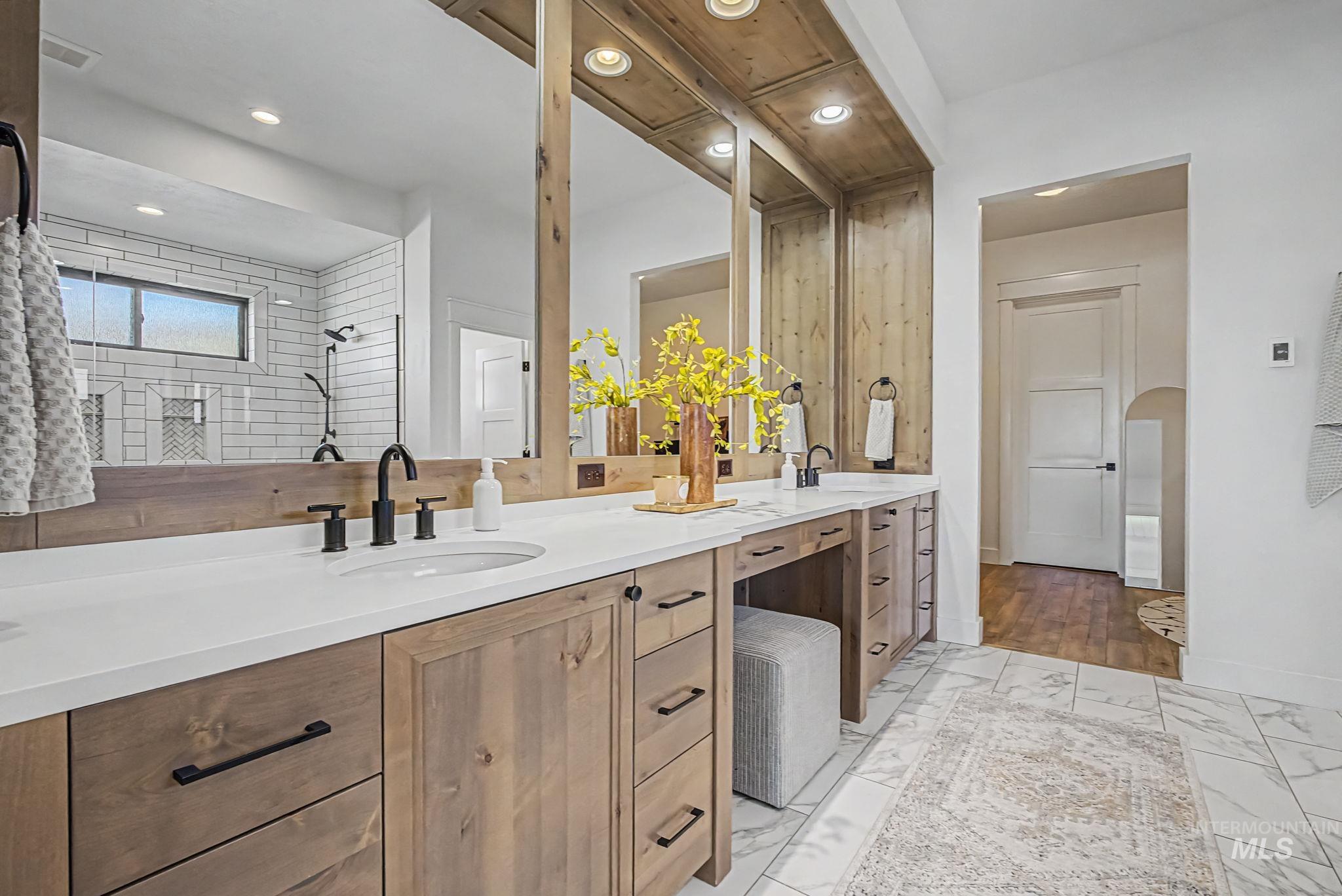 6521 South Pemberley Way Meridian, ID 83642 - Photo 23 of 42 Dual vanity featuring wood-finish cabinetry, white countertops, and matte black fixtures