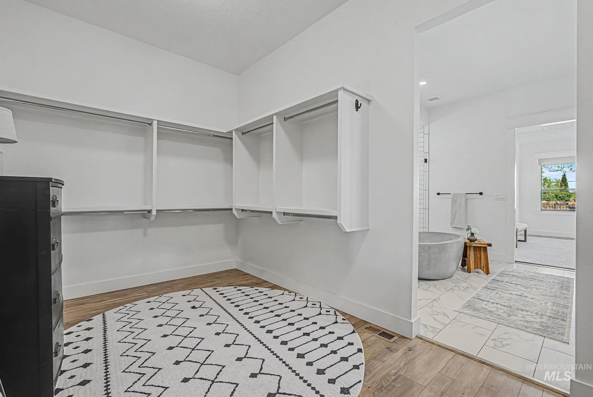 6521 South Pemberley Way Meridian, ID 83642 - Photo 25 of 42 Spacious walk-in closet featuring built-in shelving, hanging rods, and wood-finish flooring