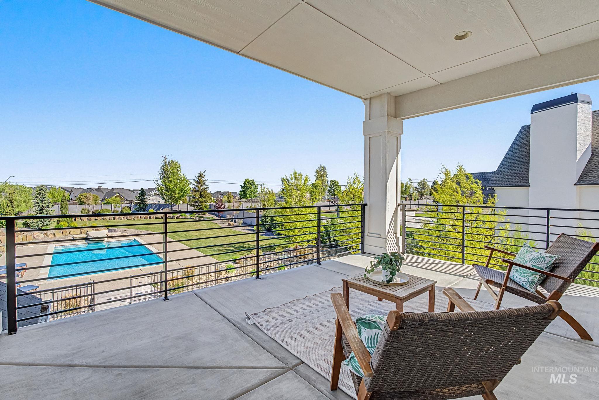 6521 South Pemberley Way Meridian, ID 83642 - Photo 27 of 42 Expansive covered patio featuring a concrete surface and black horizontal railings