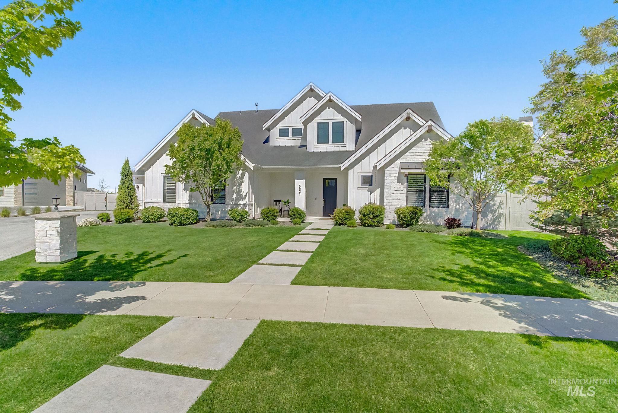 6521 South Pemberley Way Meridian, ID 83642 - Photo 3 of 42 Modern farmhouse-style exterior featuring white vertical siding and stone accents