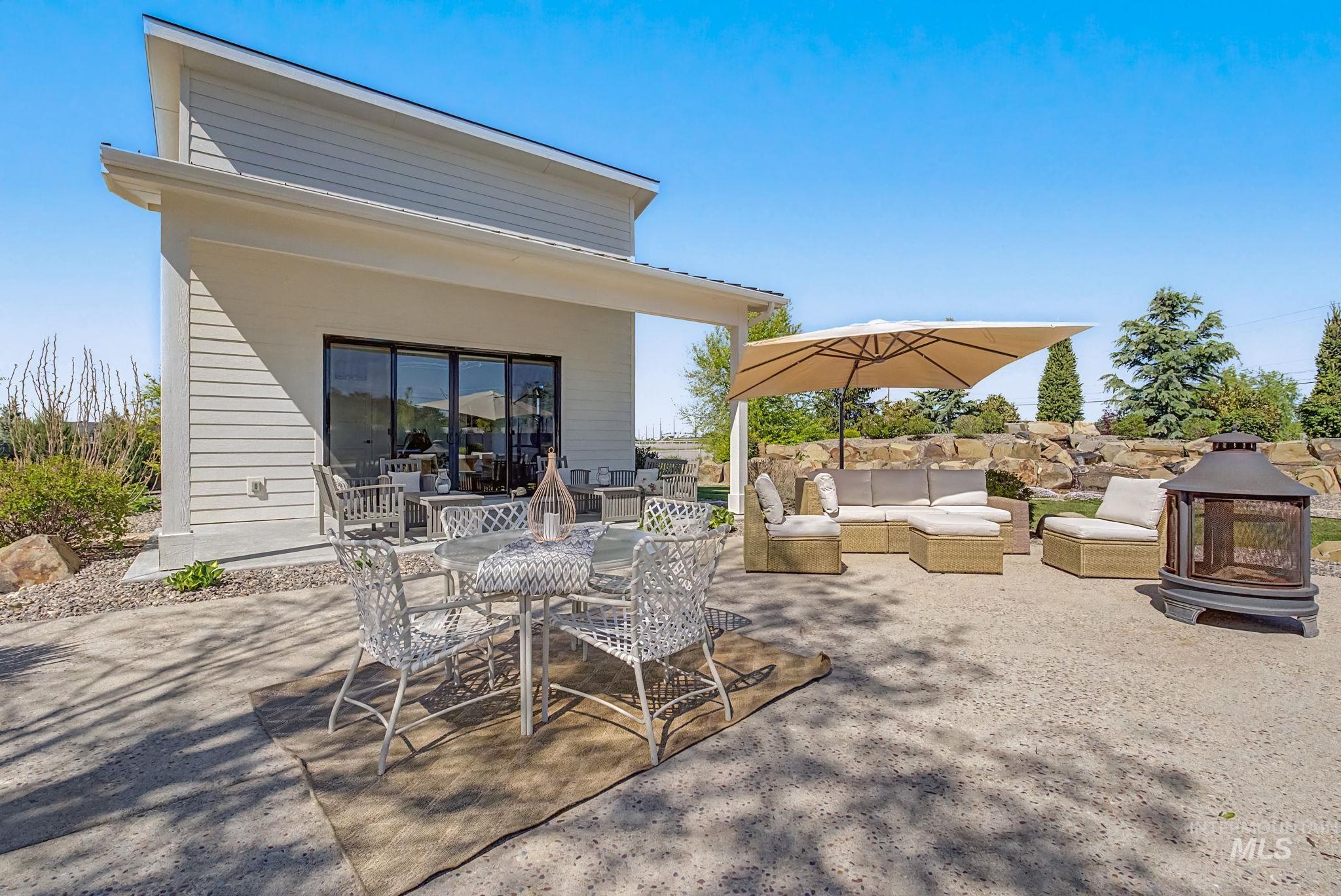 6521 South Pemberley Way Meridian, ID 83642 - Photo 36 of 42 Extensive concrete patio space featuring a contemporary pitched roofline structure with horizontal siding and large sliding glass doors