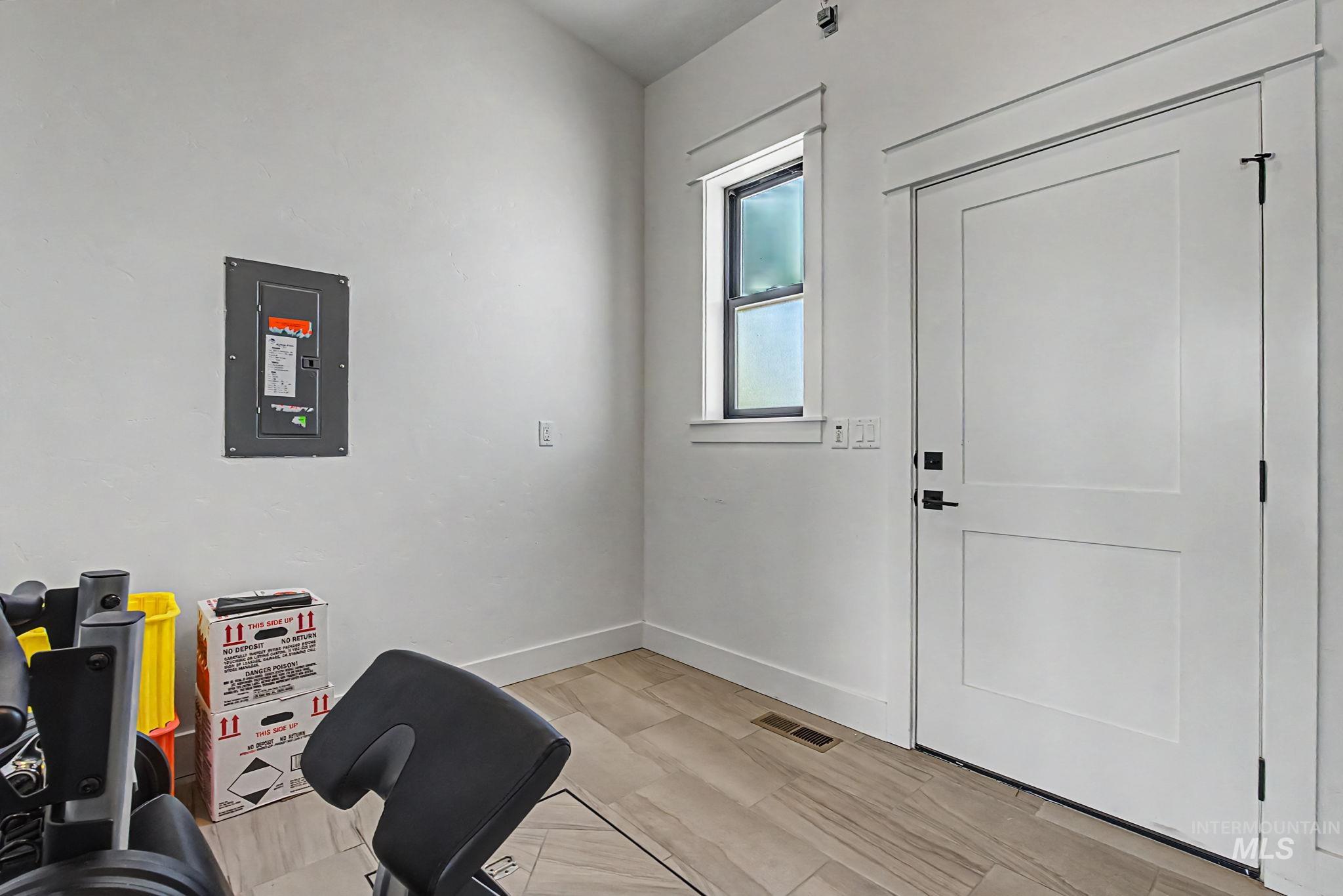 6521 South Pemberley Way Meridian, ID 83642 - Photo 37 of 42 White interior door with black hardware, framed by white trim and a coordinating window