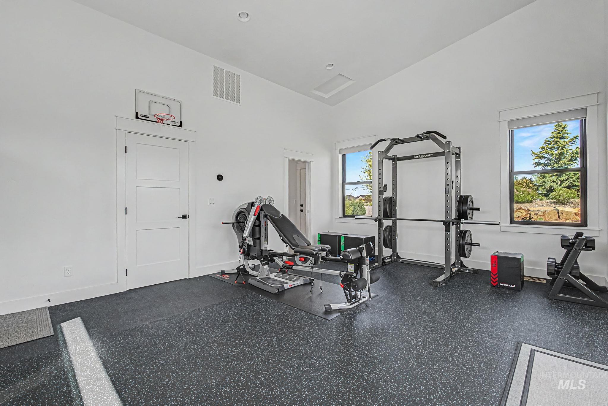 6521 South Pemberley Way Meridian, ID 83642 - Photo 38 of 42 Dedicated fitness room featuring specialized rubber flooring, ample natural light from multiple windows, and a vaulted ceiling