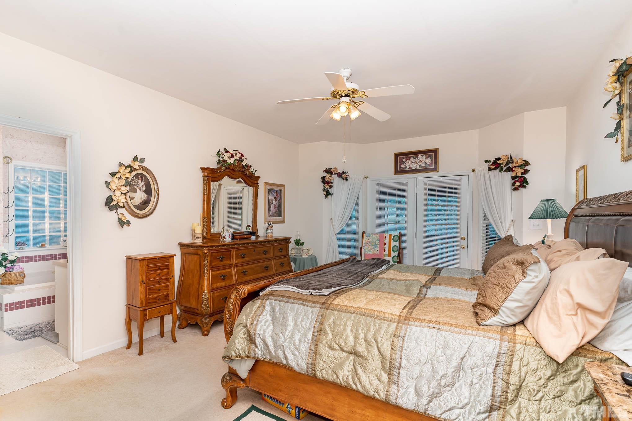 6913 Pinnacle Ridge Road Raleigh, NC 27603 - Photo 16 of 34 a bedroom with a bed and a chandelier