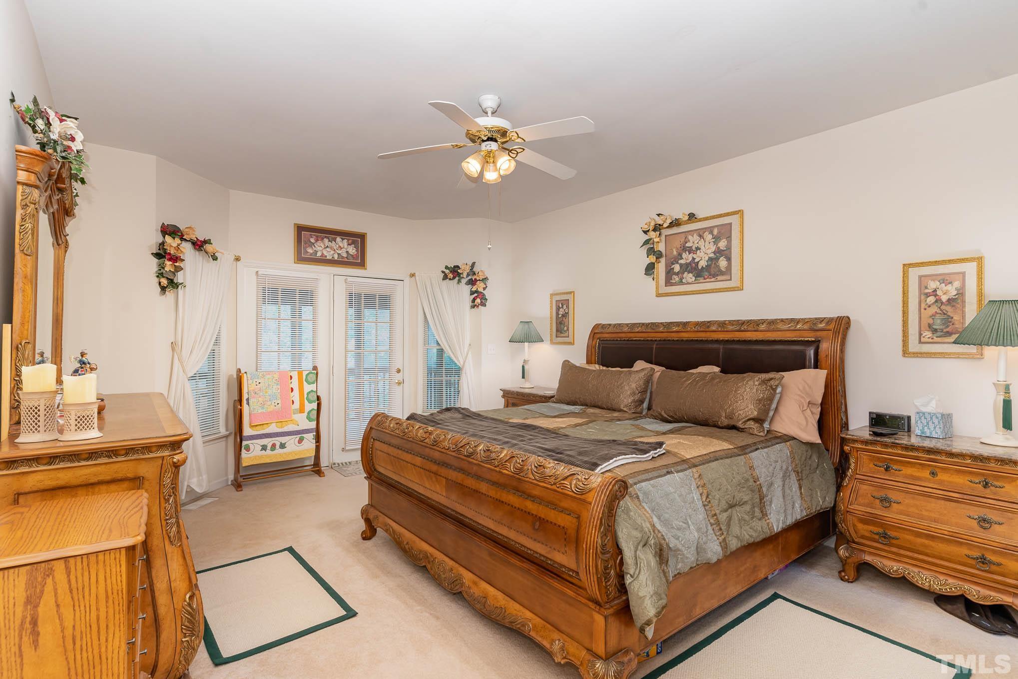6913 Pinnacle Ridge Road Raleigh, NC 27603 - Photo 17 of 34 a bedroom with a bed and a chandelier