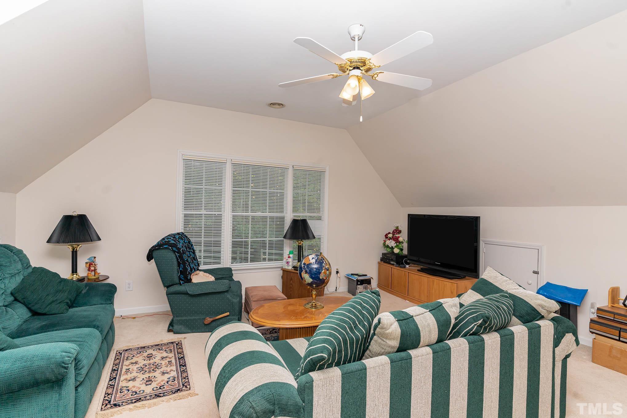 6913 Pinnacle Ridge Road Raleigh, NC 27603 - Photo 19 of 34 a living room with furniture a fireplace and a flat screen tv