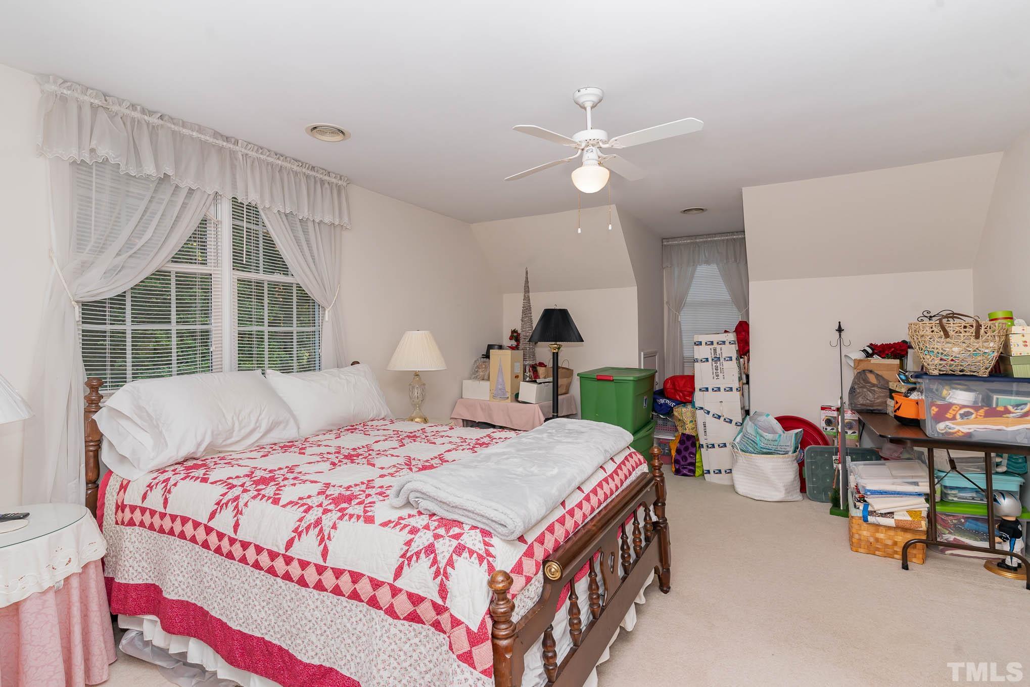 6913 Pinnacle Ridge Road Raleigh, NC 27603 - Photo 21 of 34 a bedroom with a bed and a table in it