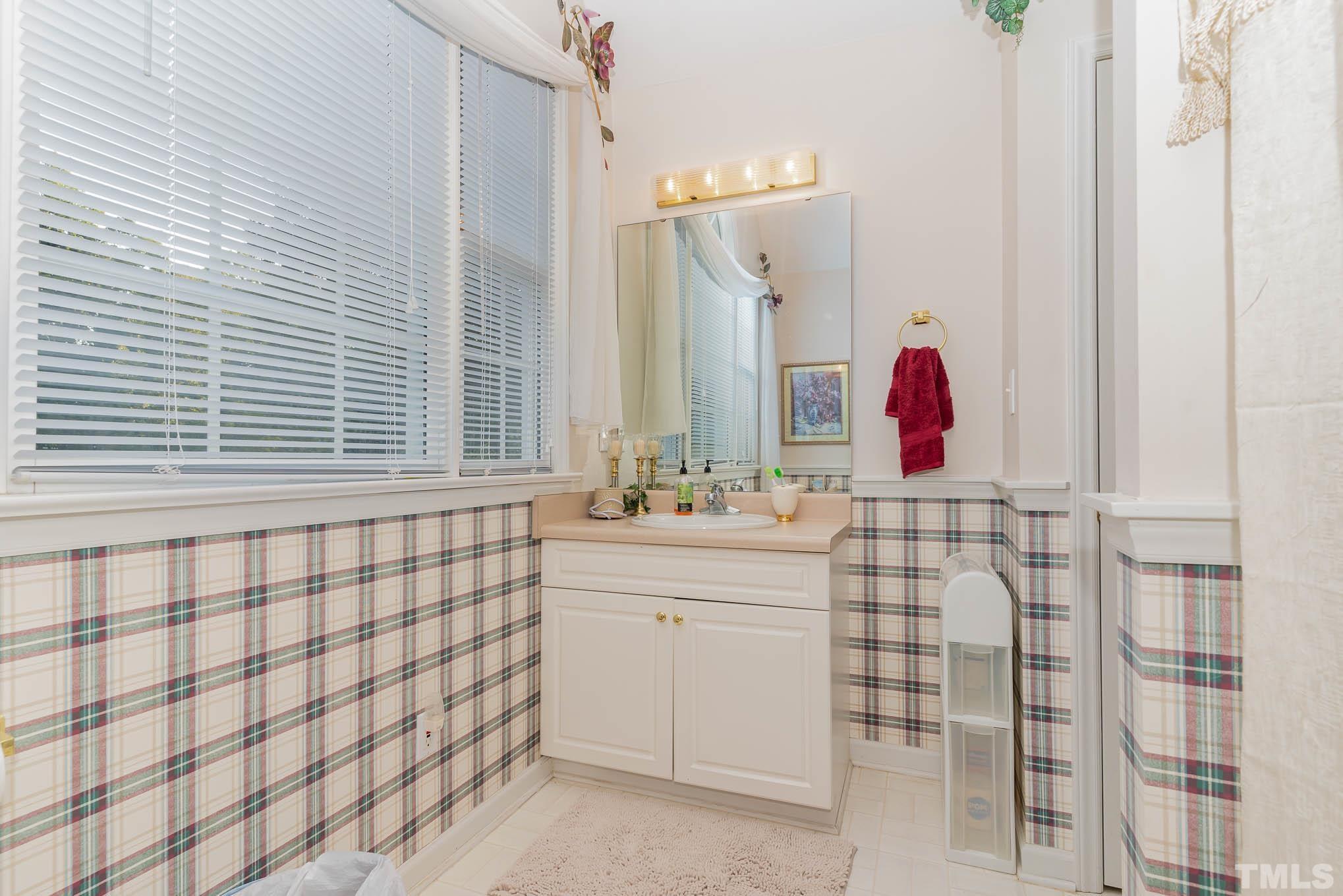 6913 Pinnacle Ridge Road Raleigh, NC 27603 - Photo 22 of 34 a bathroom with a sink and a mirror
