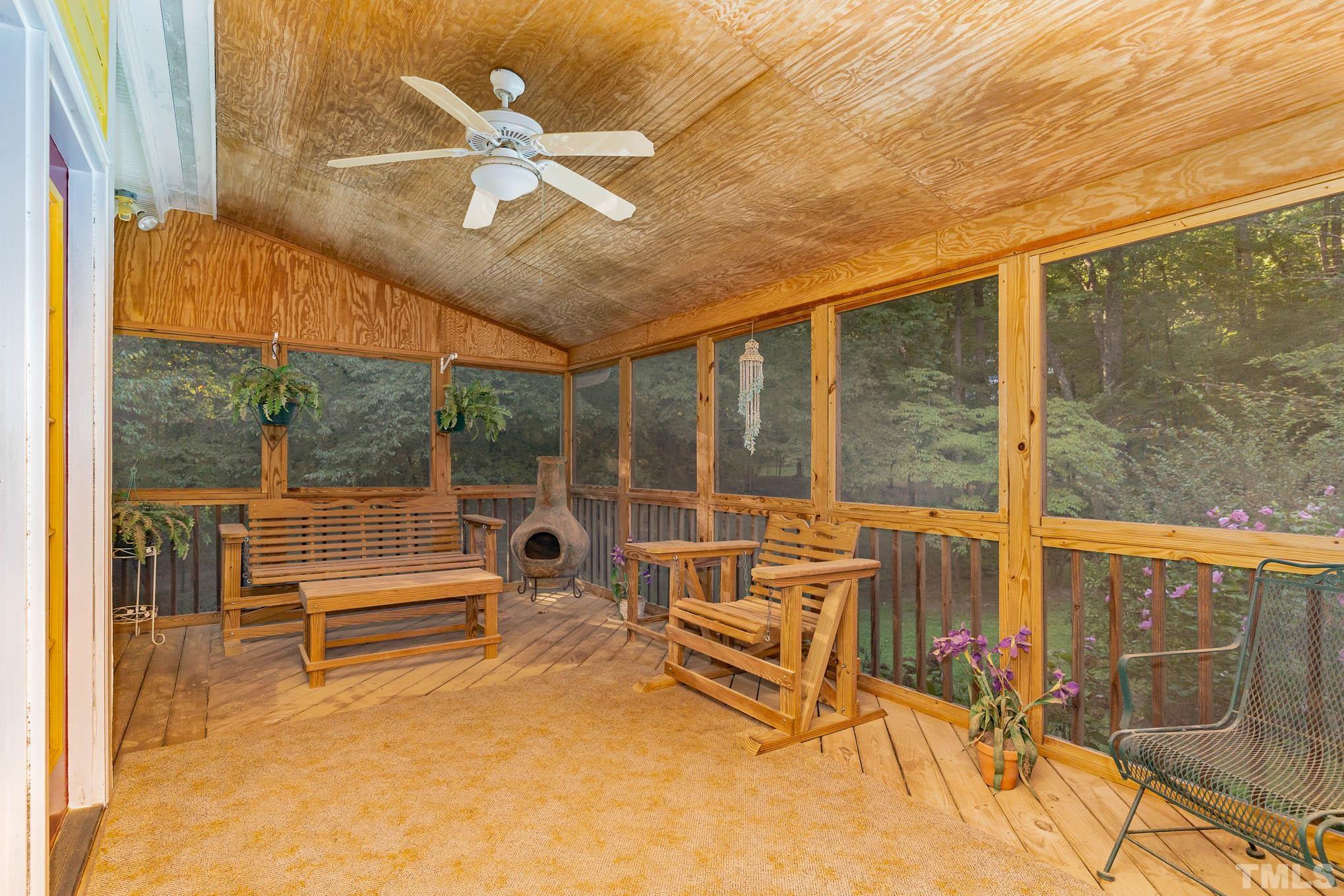 6913 Pinnacle Ridge Road Raleigh, NC 27603 - Photo 25 of 34 a living room with patio furniture and a floor to ceiling window