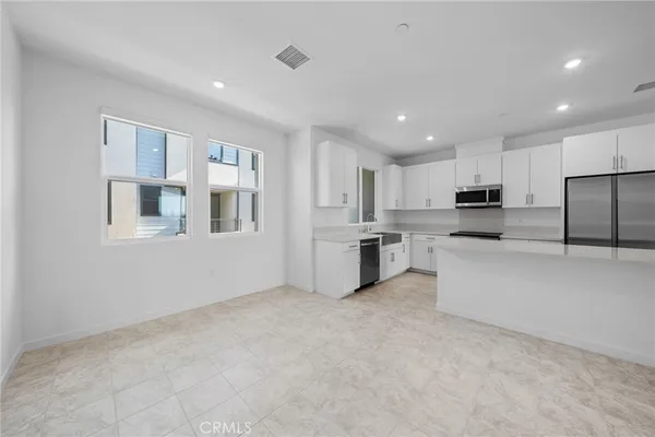 a kitchen with stainless steel appliances refrigerator oven microwave and cabinets