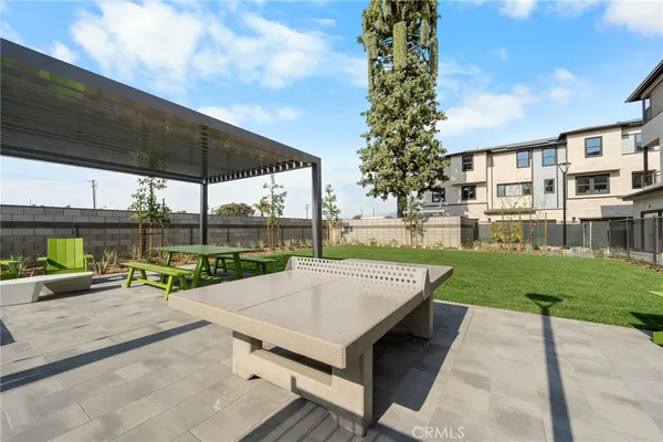 a view of a patio with a table and chairs under an umbrella