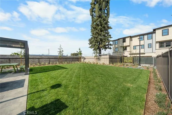 a view of a backyard with plants and outdoor seating
