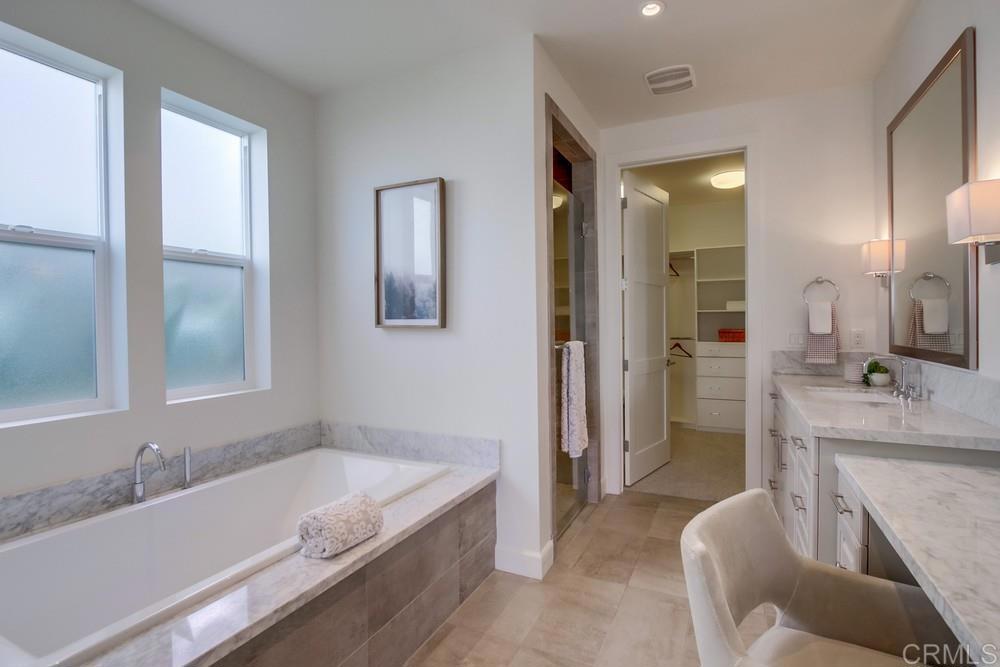 2333 Ocean Street Carlsbad, CA 92008 - Photo 24 of 67 a bathroom with a granite countertop tub a sink and a large mirror