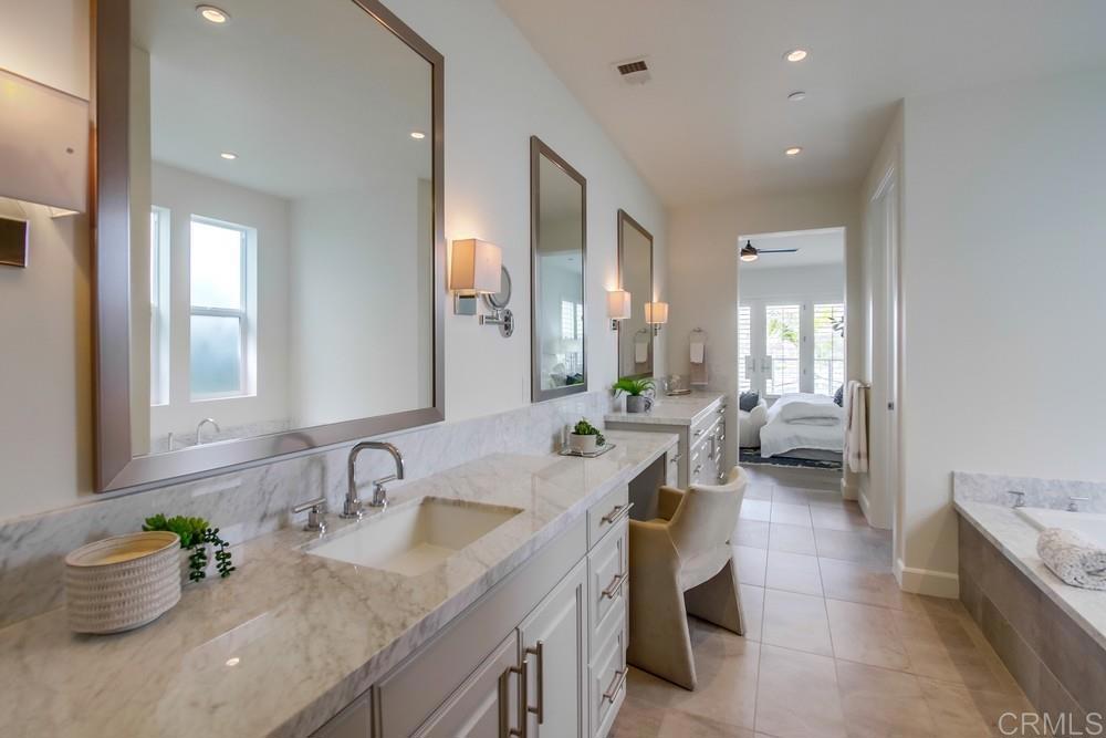 2333 Ocean Street Carlsbad, CA 92008 - Photo 26 of 67 a bathroom with a granite countertop sink mirror and vanity