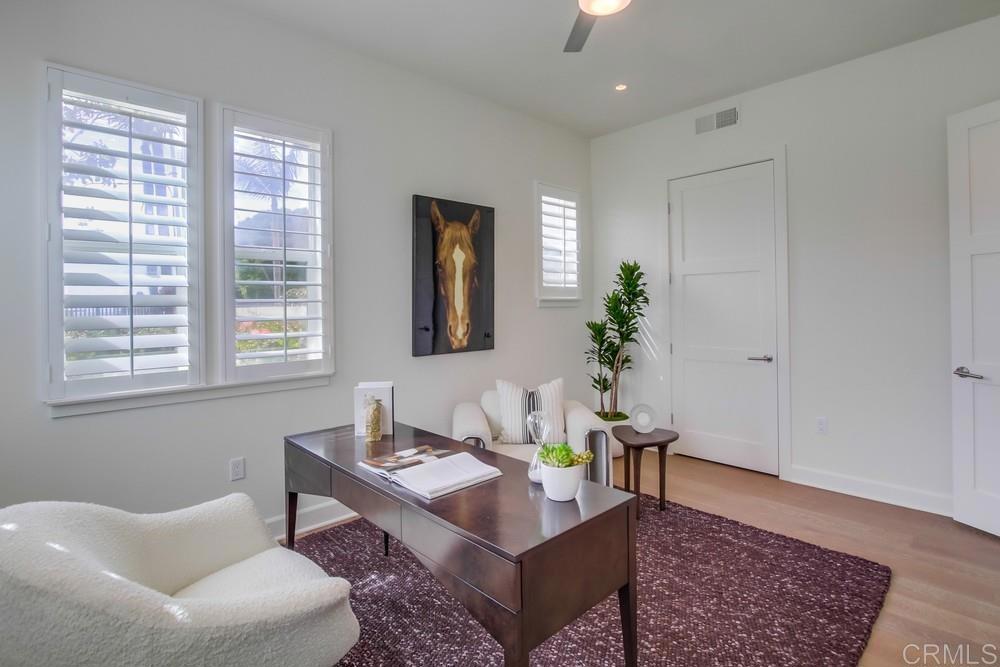 2333 Ocean Street Carlsbad, CA 92008 - Photo 28 of 67 a living room with furniture and a potted plant