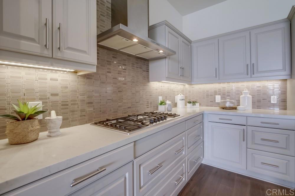 2333 Ocean Street Carlsbad, CA 92008 - Photo 6 of 67 a kitchen with stainless steel appliances white cabinets and a stove