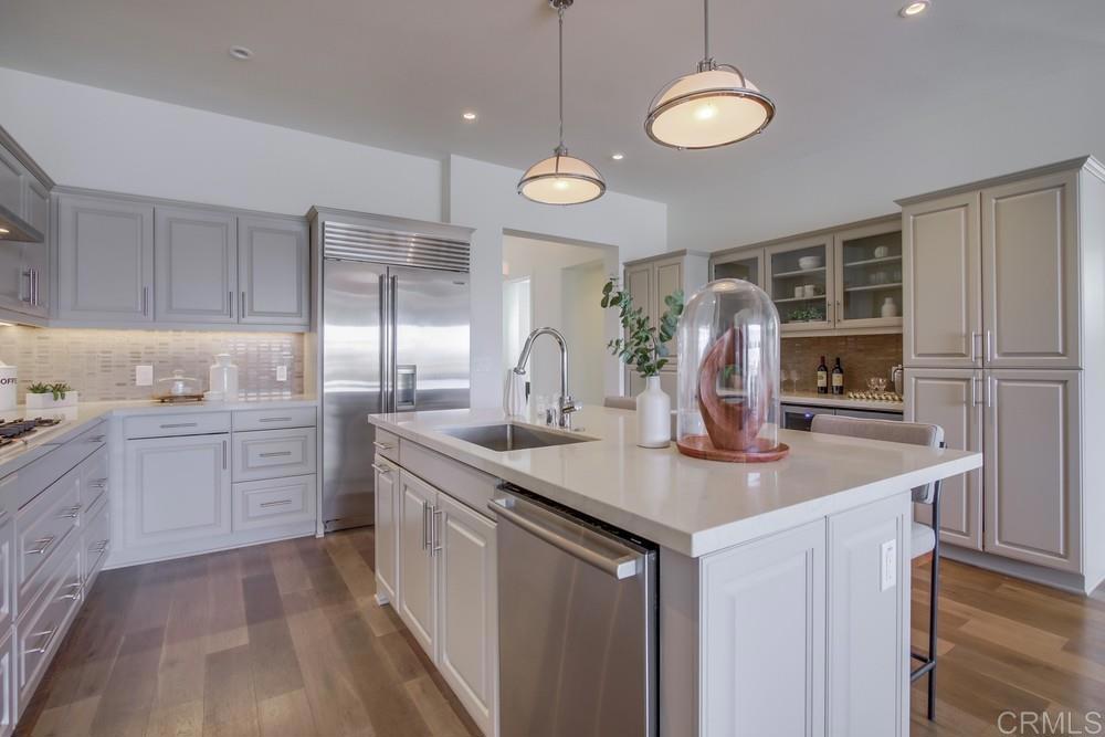 2333 Ocean Street Carlsbad, CA 92008 - Photo 8 of 67 a kitchen with stainless steel appliances granite countertop a sink a stove and a wooden floors