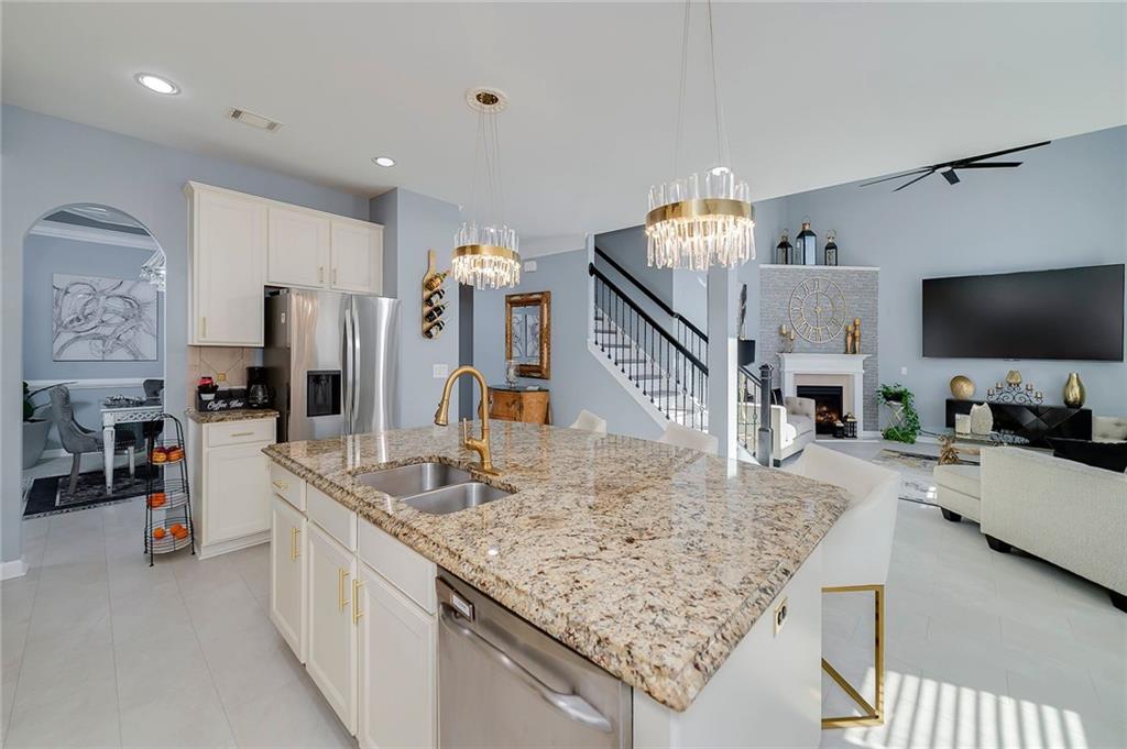 6810 Rocking Horse Lane Cumming, GA 30040 - Photo 13 of 39 a kitchen with stainless steel appliances granite countertop a sink refrigerator and microwave