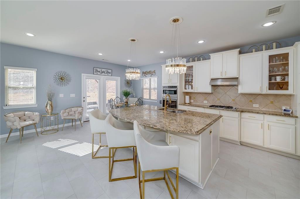 6810 Rocking Horse Lane Cumming, GA 30040 - Photo 14 of 39 a kitchen with stainless steel appliances granite countertop counter top space a sink cabinets and a window