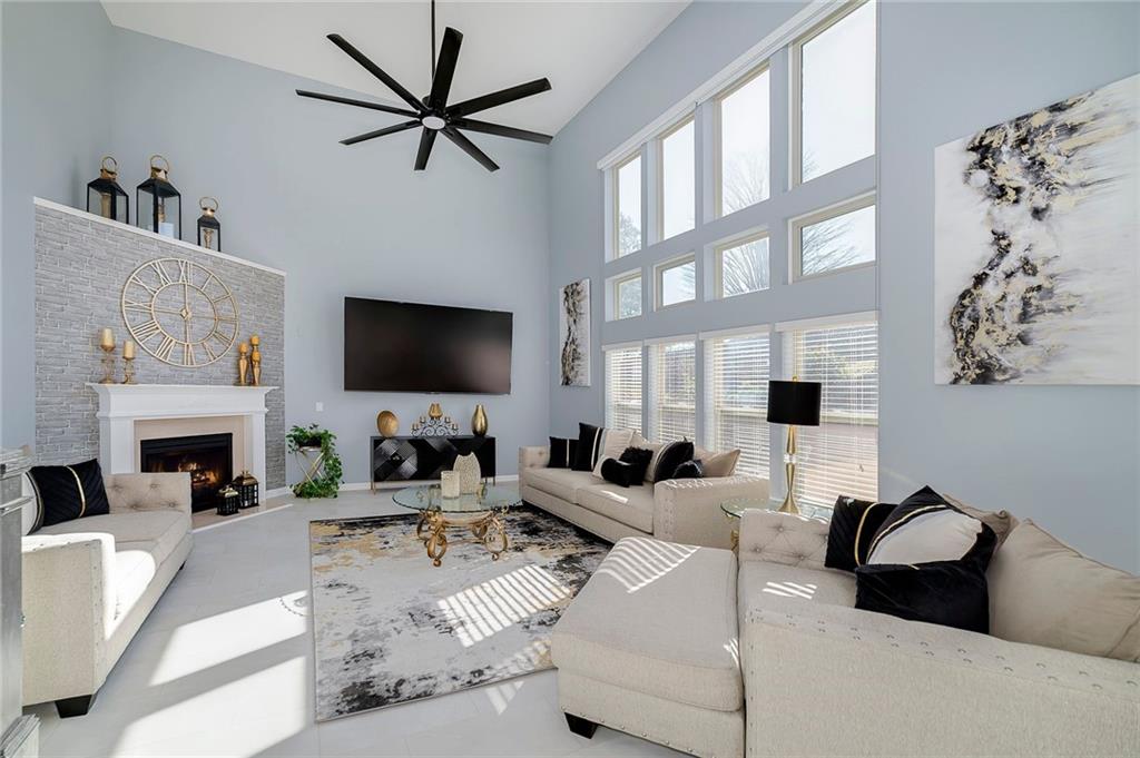 6810 Rocking Horse Lane Cumming, GA 30040 - Photo 18 of 39 a living room with furniture a fireplace and a flat screen tv
