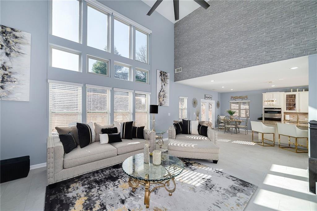 6810 Rocking Horse Lane Cumming, GA 30040 - Photo 19 of 39 a living room with furniture or couch and a large window