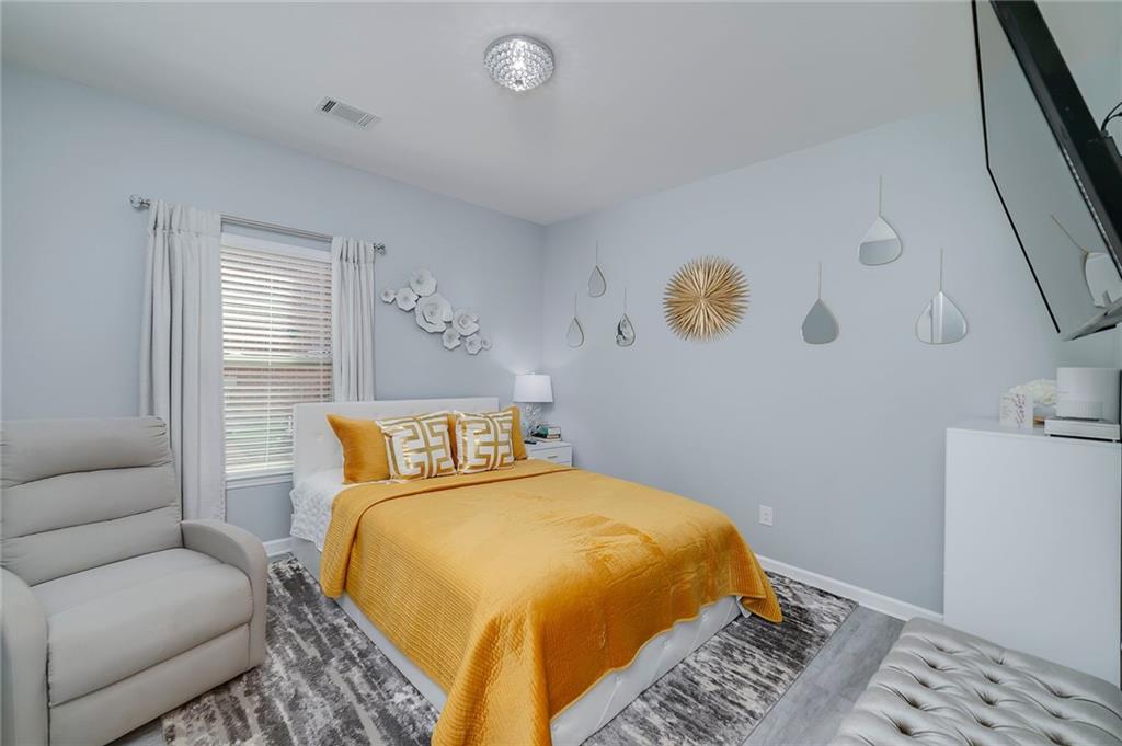 6810 Rocking Horse Lane Cumming, GA 30040 - Photo 20 of 39 a bedroom with a bed and couch