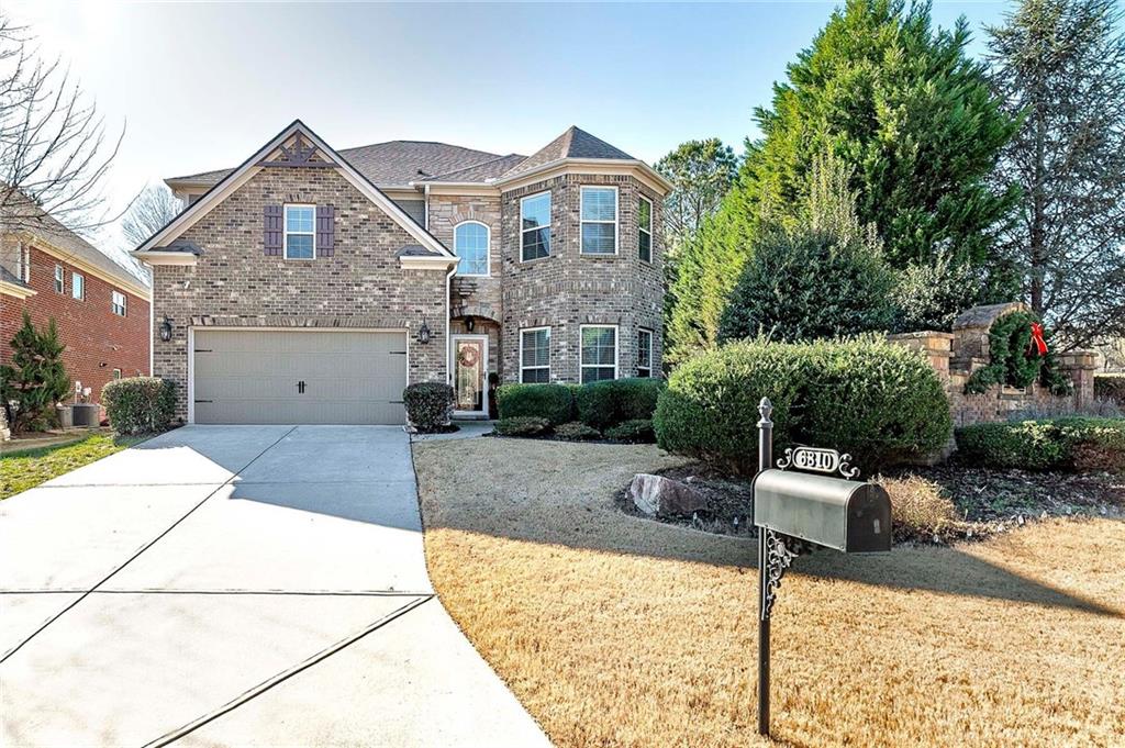 6810 Rocking Horse Lane Cumming, GA 30040 - Photo 2 of 39 a front view of a house with garden