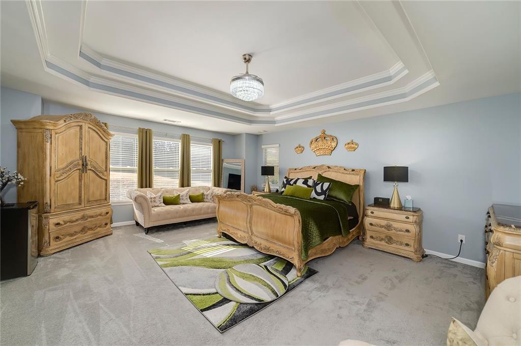 6810 Rocking Horse Lane Cumming, GA 30040 - Photo 23 of 39 a bedroom with a bed and wooden floor