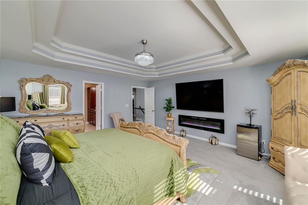 6810 Rocking Horse Lane Cumming, GA 30040 - Photo 24 of 39 a bedroom with a bed and a flat screen tv