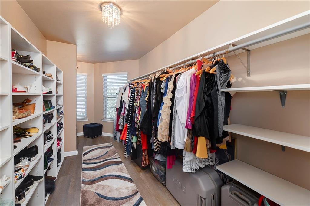 6810 Rocking Horse Lane Cumming, GA 30040 - Photo 27 of 39 a view of walk in closet with clothes and shoes