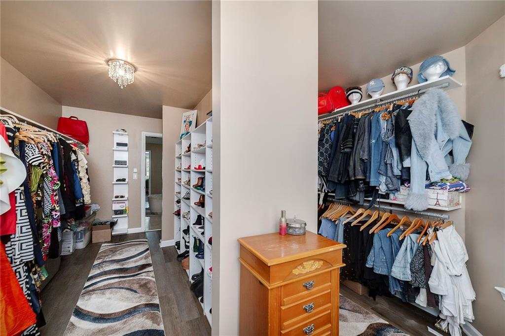 6810 Rocking Horse Lane Cumming, GA 30040 - Photo 28 of 39 a view of walk in closet with clothes and shoes