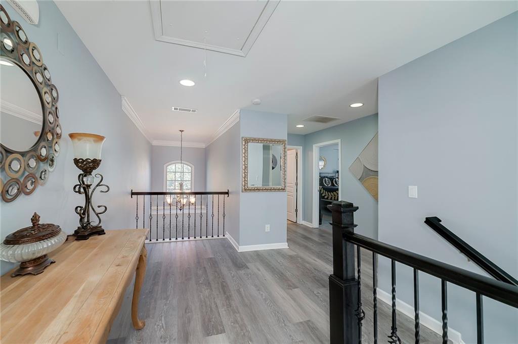 6810 Rocking Horse Lane Cumming, GA 30040 - Photo 29 of 39 a view of a hallway with wooden floor and staircase