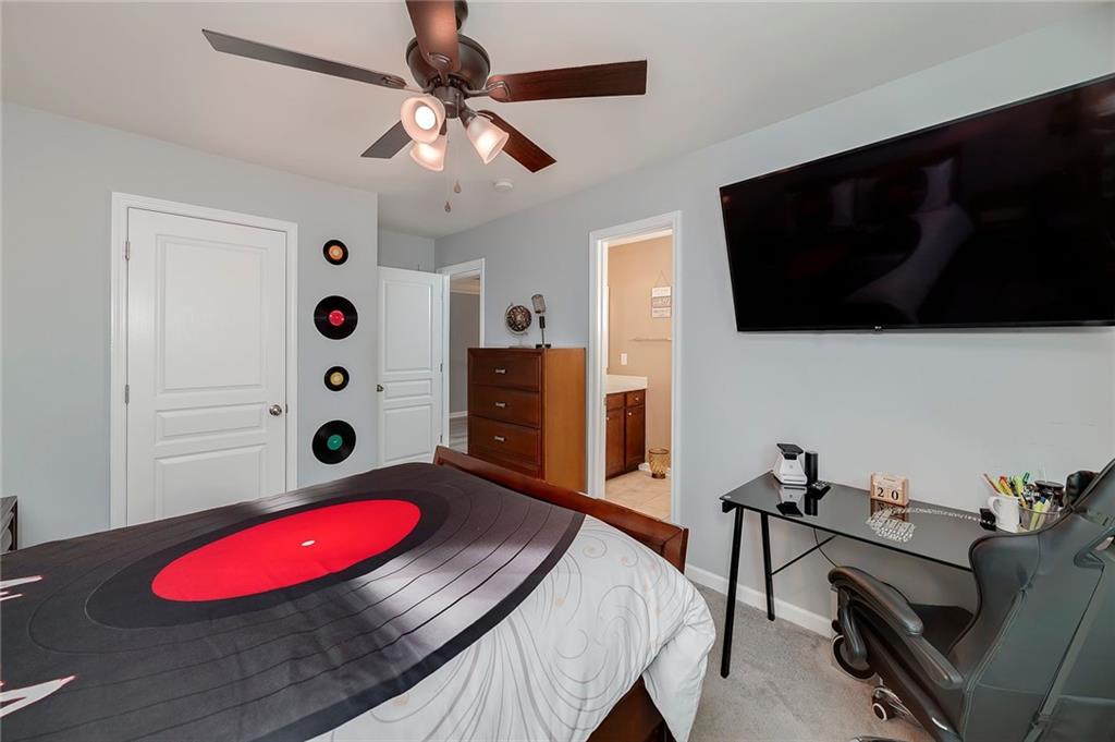 6810 Rocking Horse Lane Cumming, GA 30040 - Photo 31 of 39 a living room with furniture and a flat screen tv