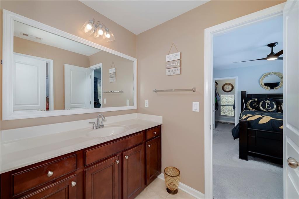 6810 Rocking Horse Lane Cumming, GA 30040 - Photo 32 of 39 a bathroom with a sink and a mirror