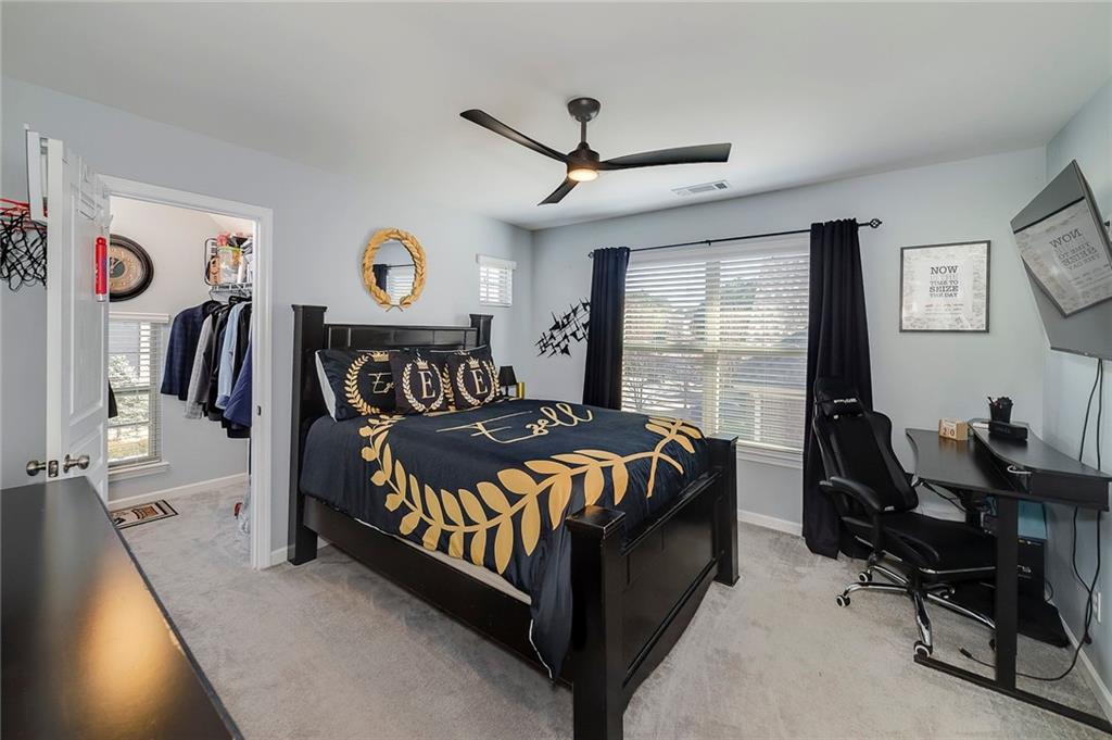 6810 Rocking Horse Lane Cumming, GA 30040 - Photo 34 of 39 a bedroom with a bed and a window