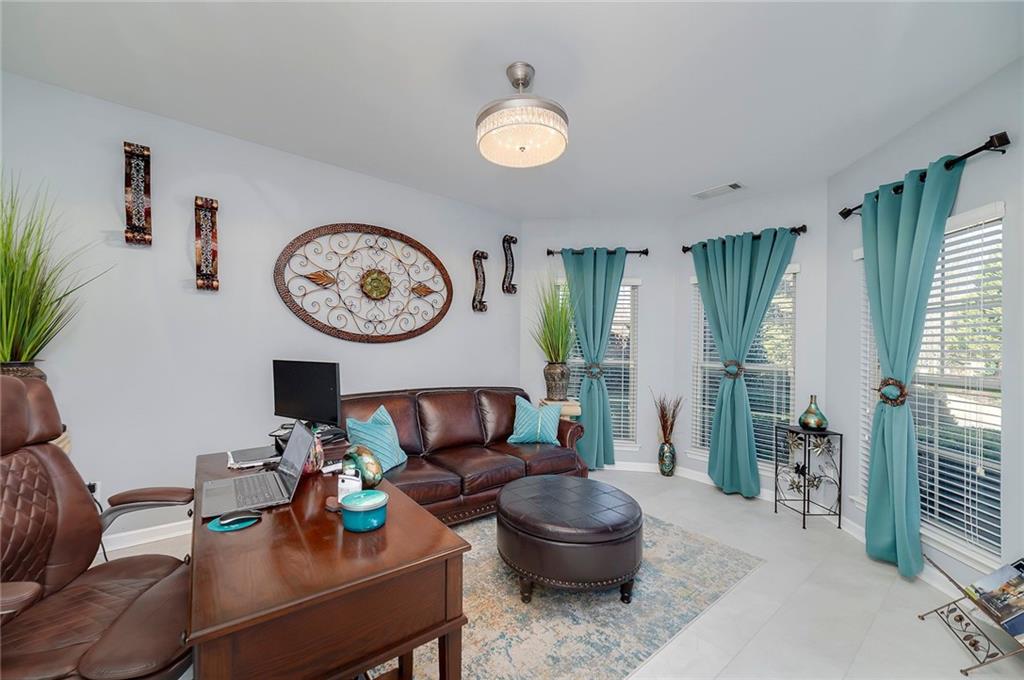 6810 Rocking Horse Lane Cumming, GA 30040 - Photo 5 of 39 a living room with furniture and a large window