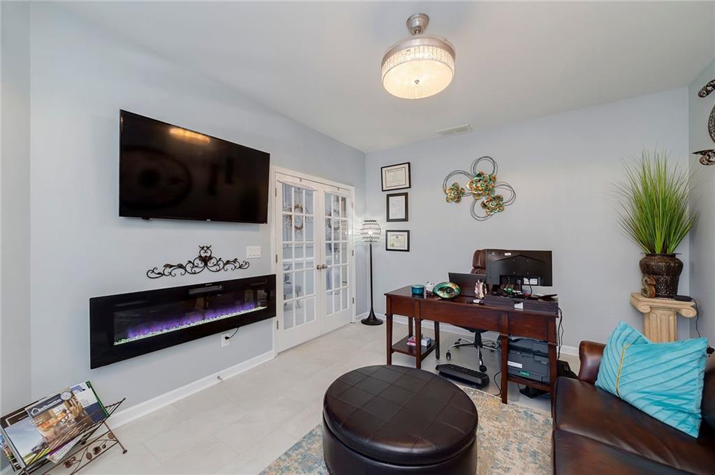 6810 Rocking Horse Lane Cumming, GA 30040 - Photo 6 of 39 a living room with furniture and a flat screen tv