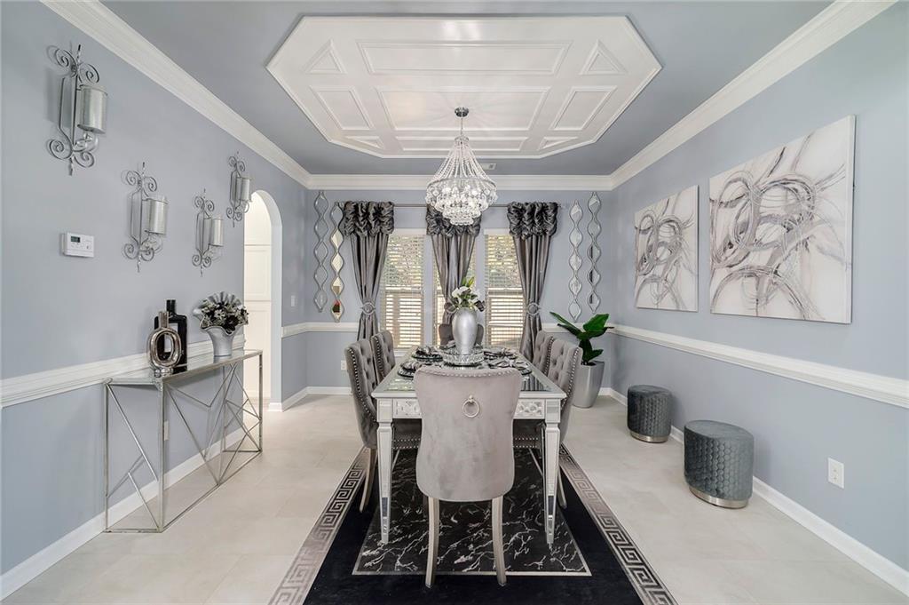 6810 Rocking Horse Lane Cumming, GA 30040 - Photo 8 of 39 a view of a dining room with furniture a chandelier and a chandelier