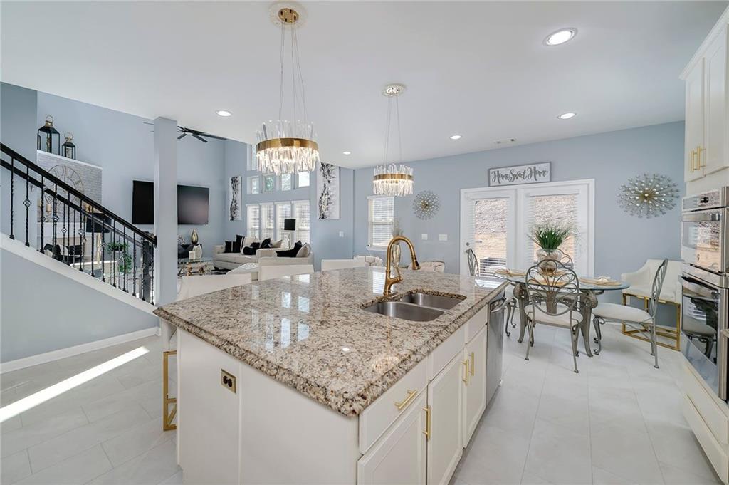 6810 Rocking Horse Lane Cumming, GA 30040 - Photo 10 of 39 a kitchen with center island table and chairs