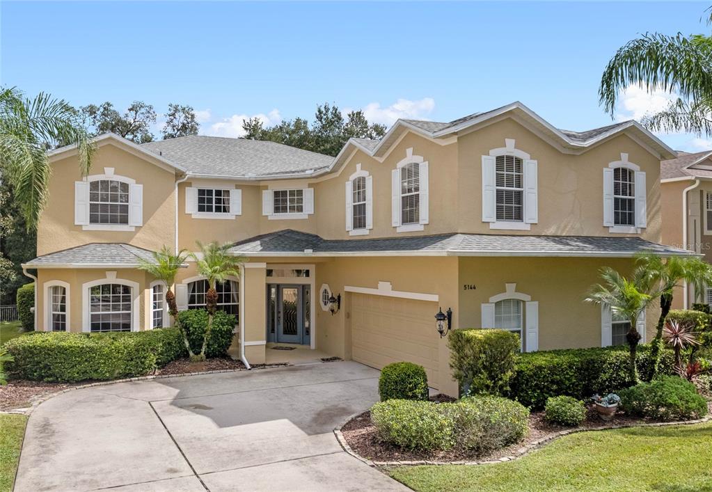 5144 Rishley Run Way Mount Dora, FL 32757 - Photo 1 of 1 a front view of a house with a yard and garage